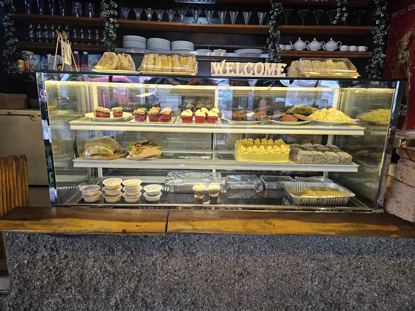 Food display case with cakes, pastries and sandwiches at The Island
